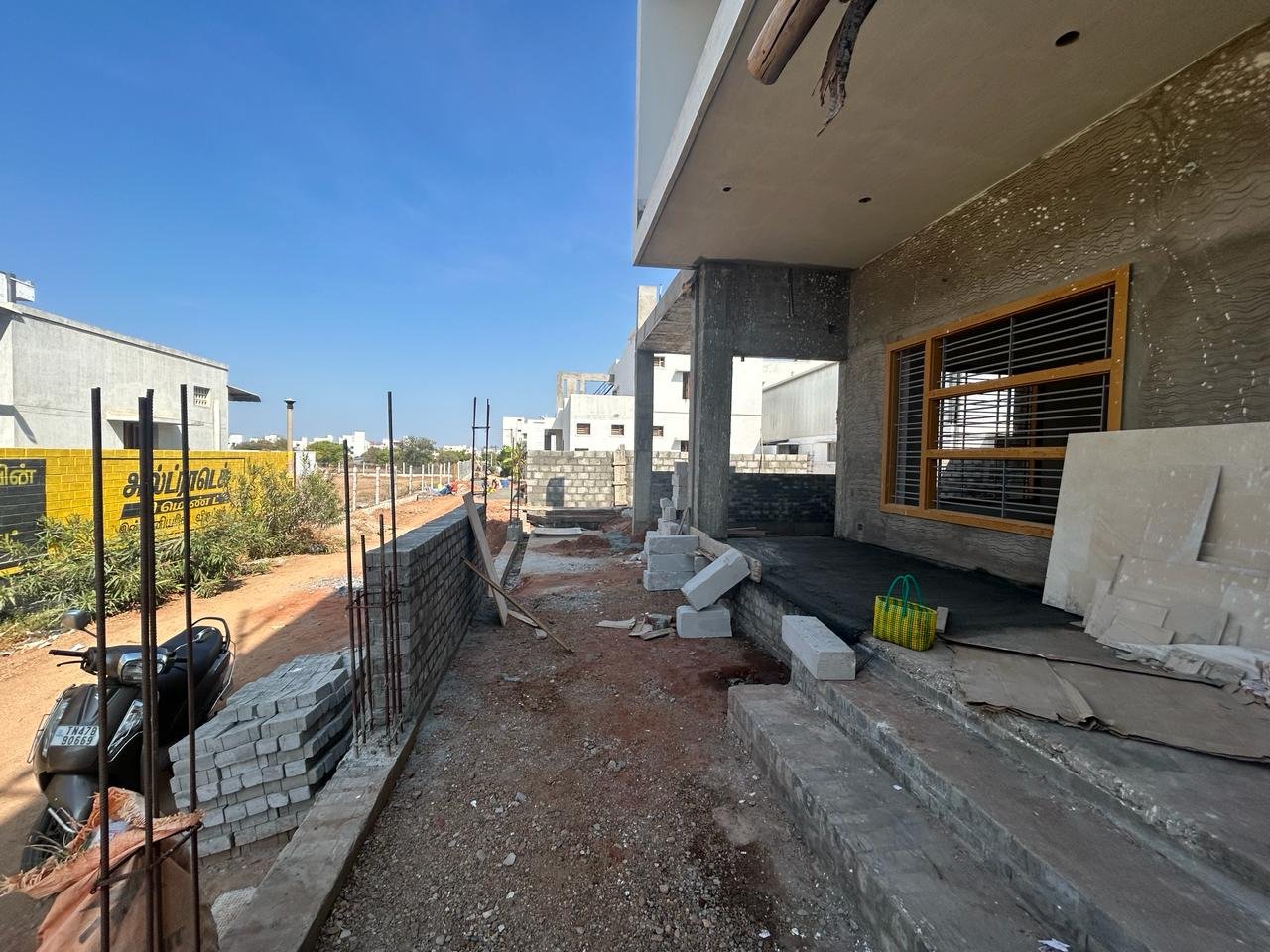 Porch and entrance under construction with materials staged on site