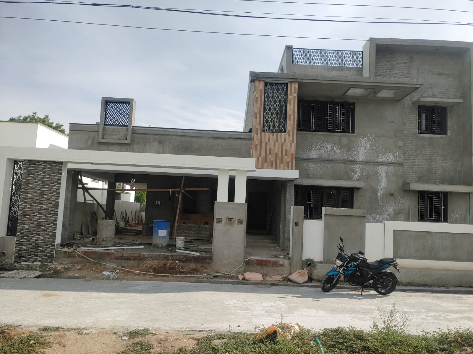 Residence exterior at finishing stage with compound wall and gate