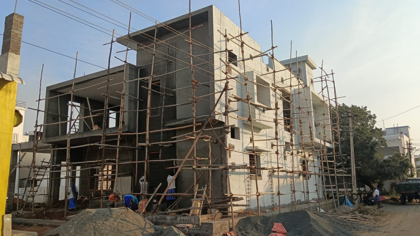 Multi-storey building under construction with bamboo scaffolding