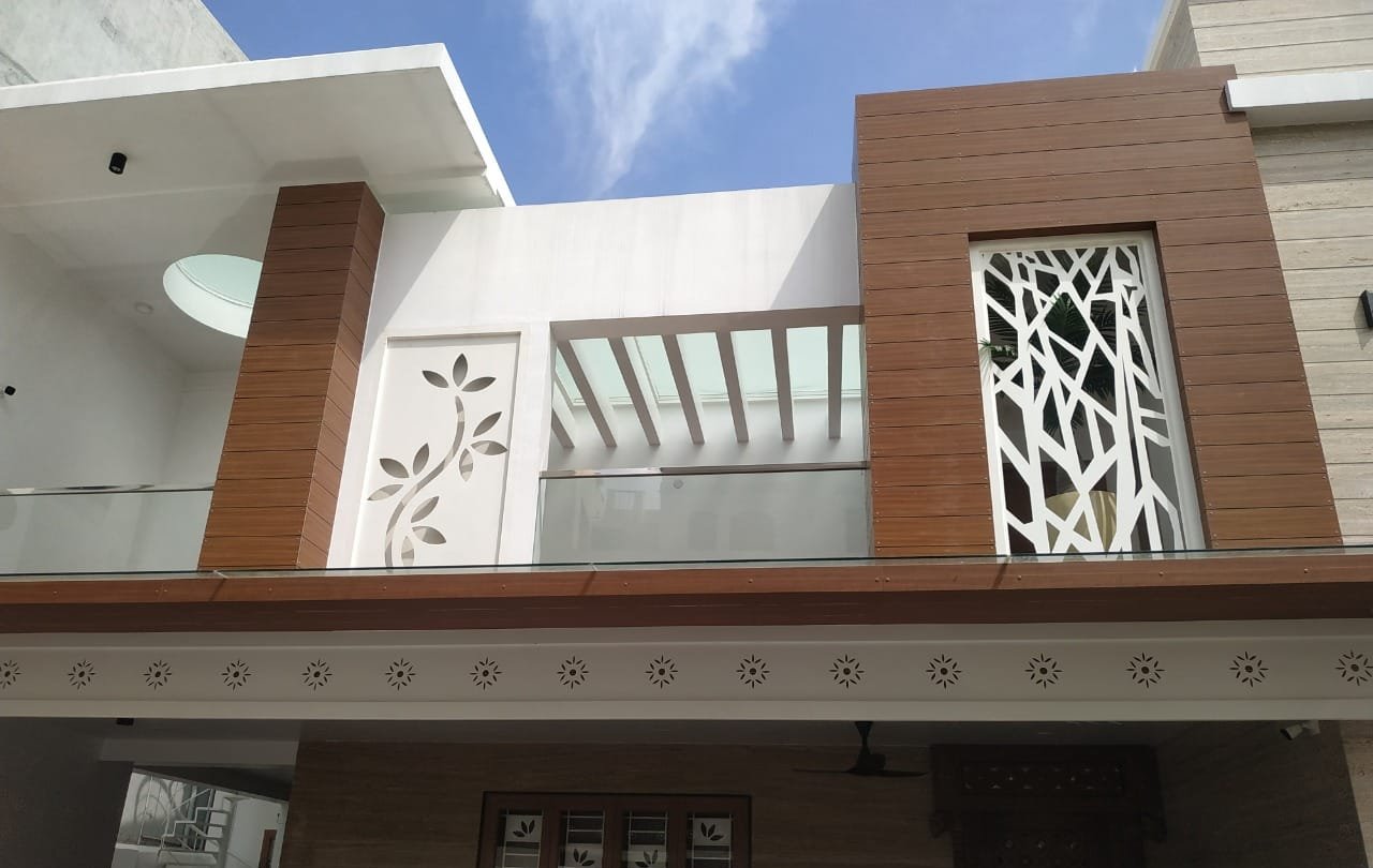 Villa facade detailing with wood cladding and jali screen