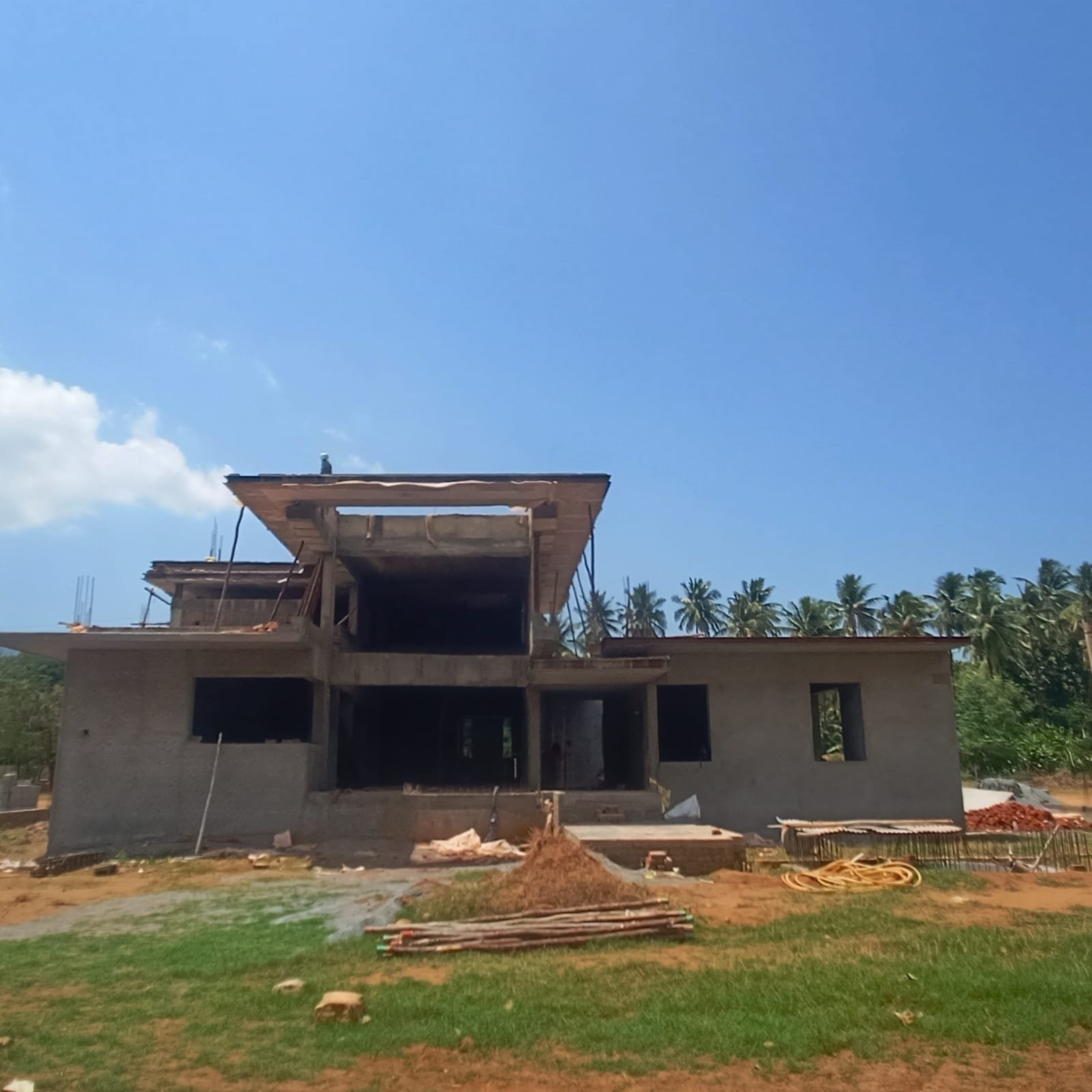 Villa under construction at structural stage on a large plot in Karur