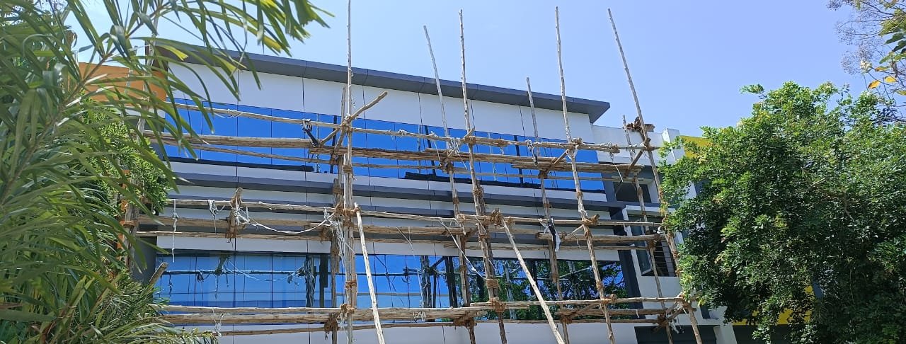 Commercial building at finishing stage with scaffolding in Karur